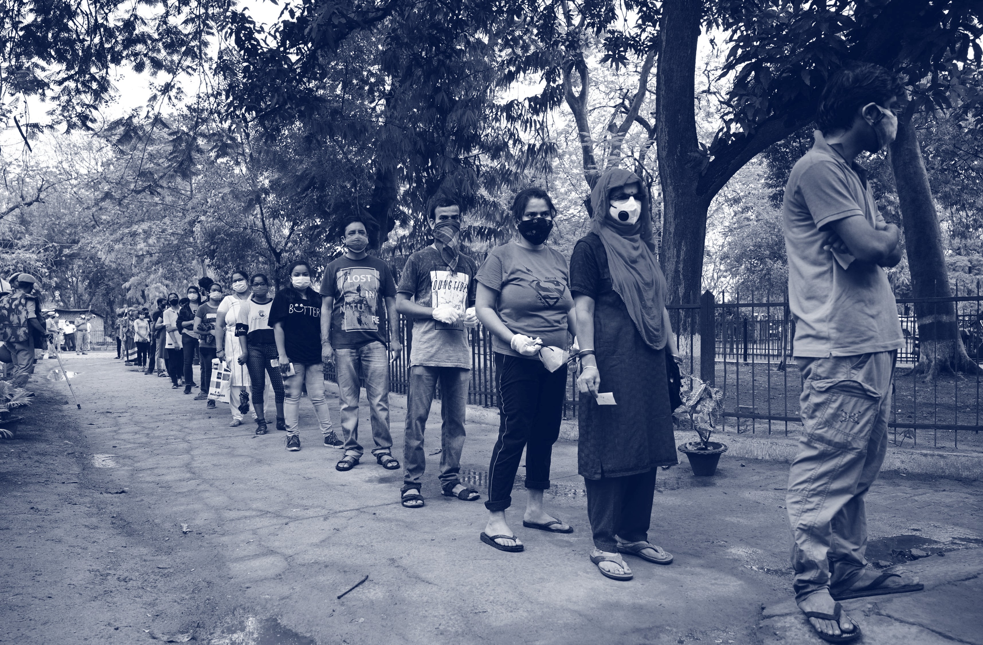 People queueing in a line with facemasks on. Credit: Shutterstock 